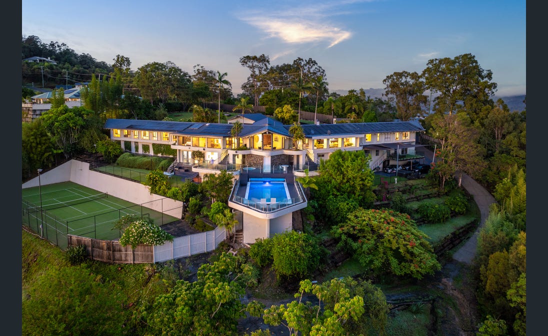 Haven at dusk, pool and tennis court above the hinterland